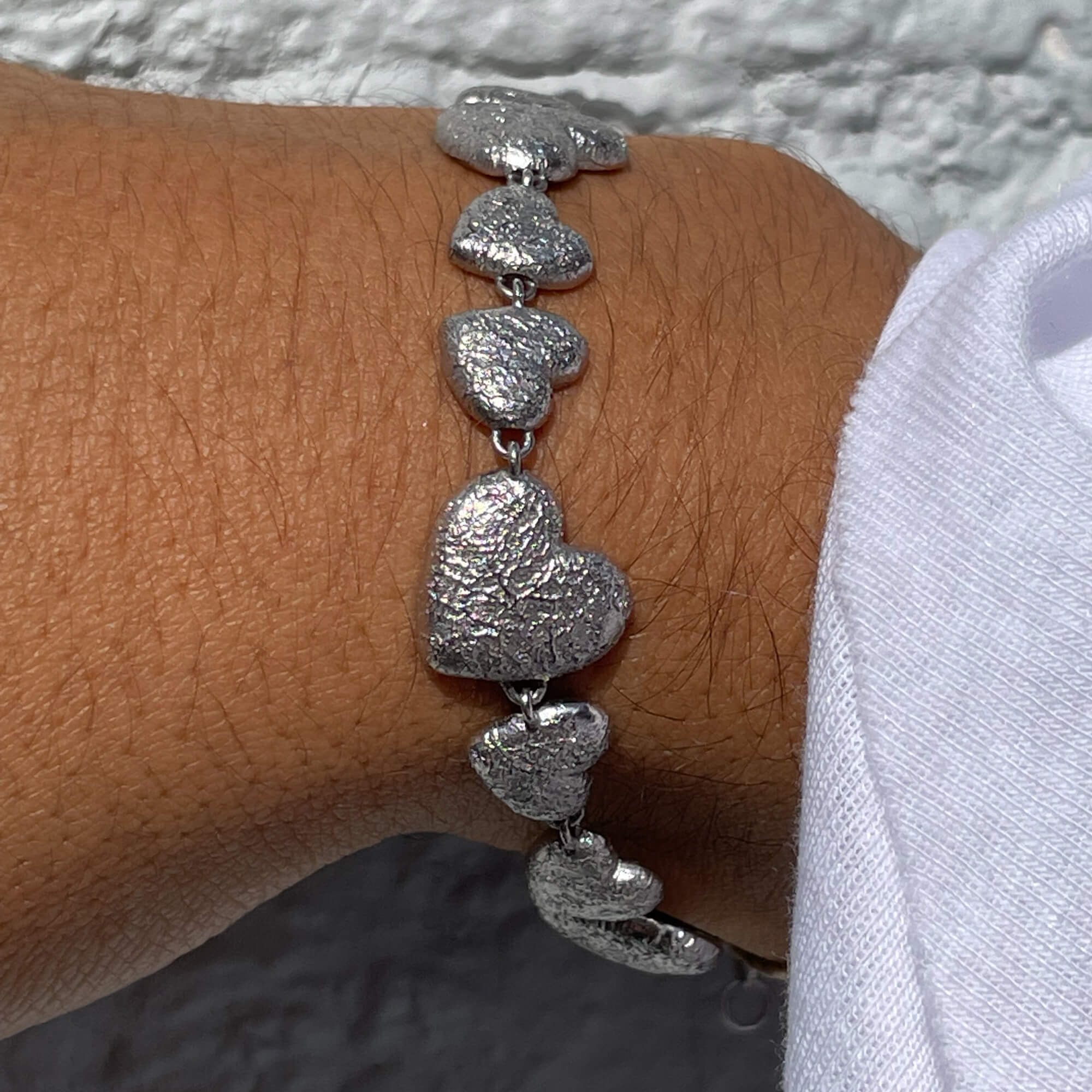 Silver bracelet with multiple hearts