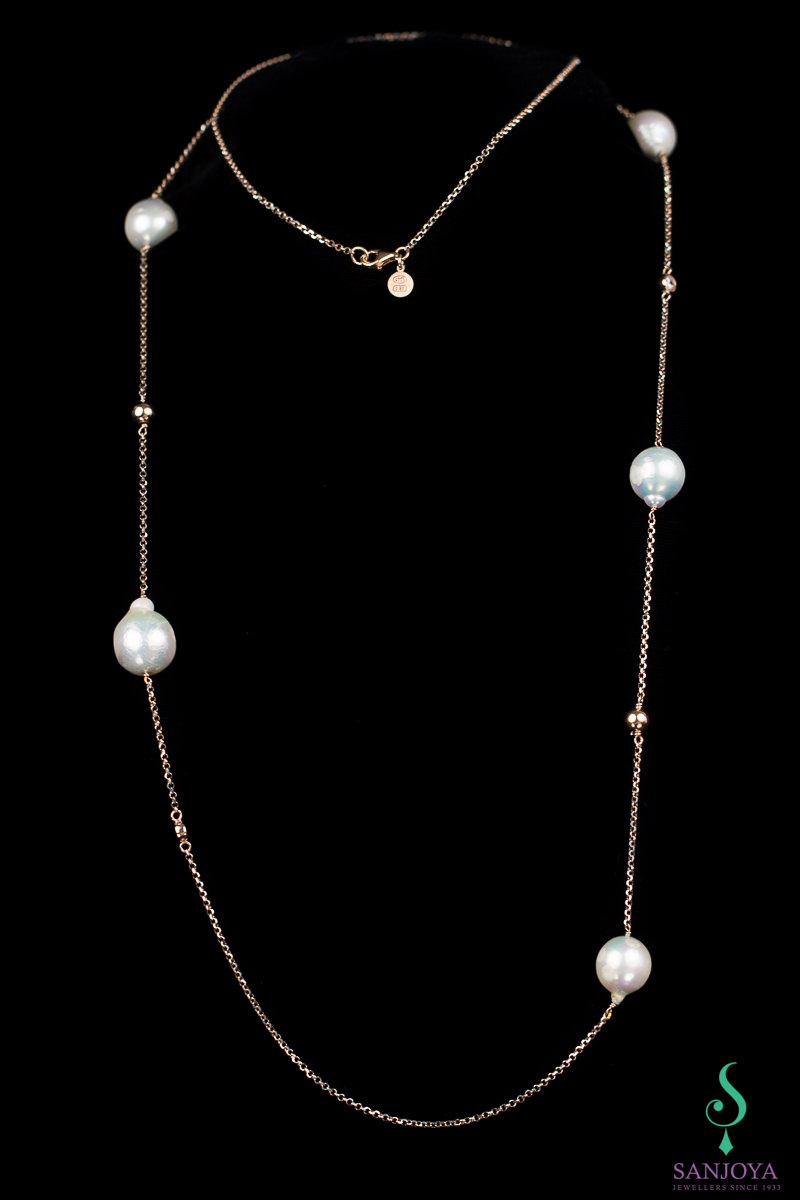 Long necklace from rosé with pearls and zirconia